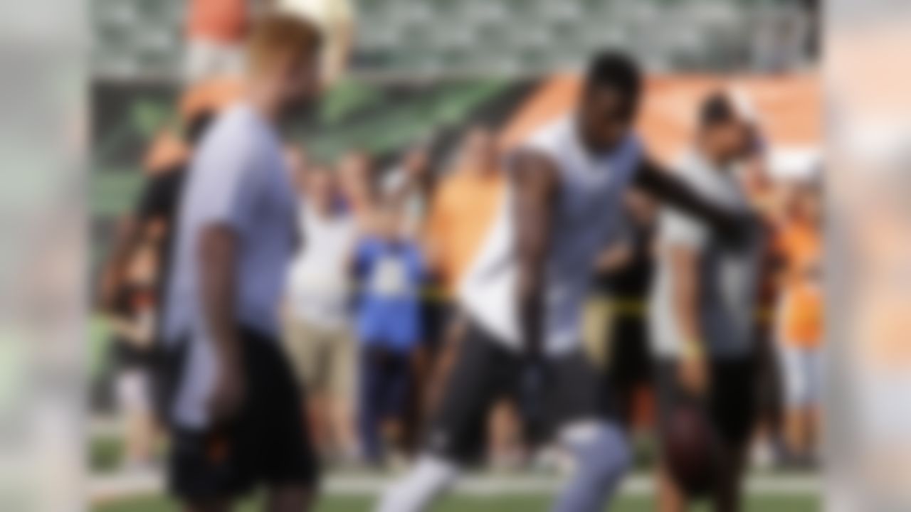 Cincinnati Bengals quarterback Andy Dalton, left, watches wide receiver A.J. Green practice a drop kick during prior to an NFL preseason football game against the Indianapolis Colts, Thursday, Aug. 28, 2014, in Cincinnati. (AP Photo/Al Behrman)