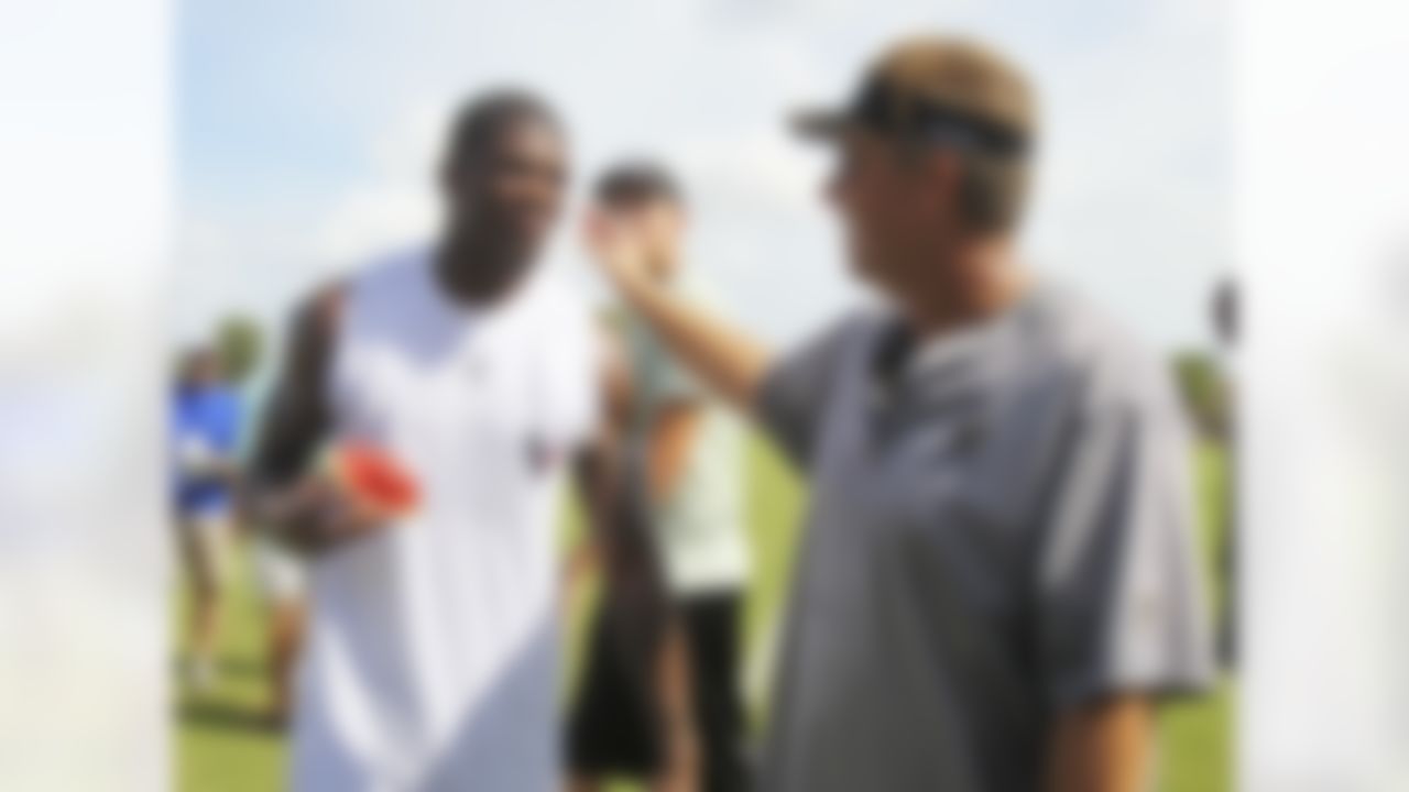 Houston Texans wide receiver Andre Johnson (80) talks with New Orleans Satins defensive coordinator Gregg Williams, right, during NFL football training camp in Metairie, La., Thursday, Aug. 19, 2010. The Saints and the Texans are holding joint practice session leading up to their preseason game on Saturday night.  (AP Photo/Bill Haber)