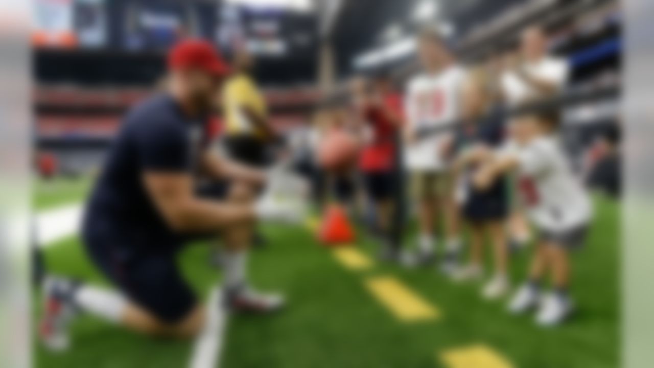 Houston Texans defensive end J.J. Watt (99) tosses a ball with fans prior to an NFL football game Sunday, Sept. 10, 2017, in Houston.