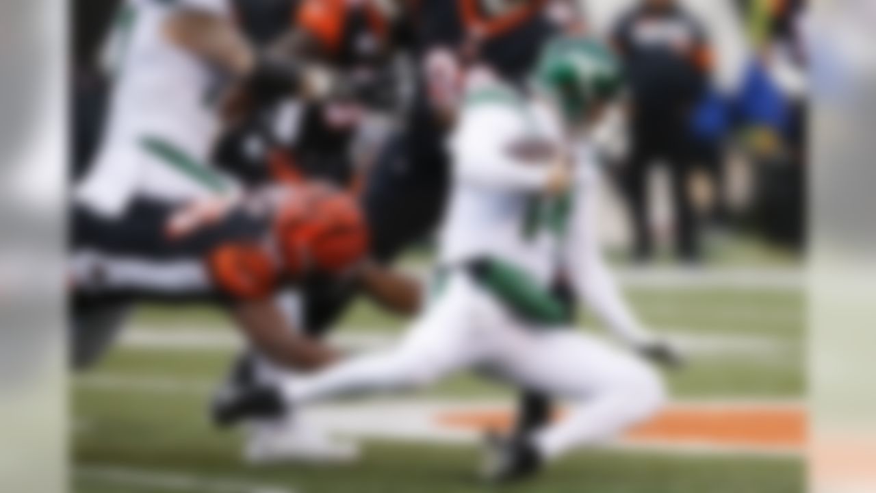 New York Jets quarterback Sam Darnold (14) dives for yardage against Cincinnati Bengals defensive end Carlos Dunlap (96) during the first half of an NFL football game, Sunday, Dec. 1, 2019, in Cincinnati. (AP Photo/Gary Landers)