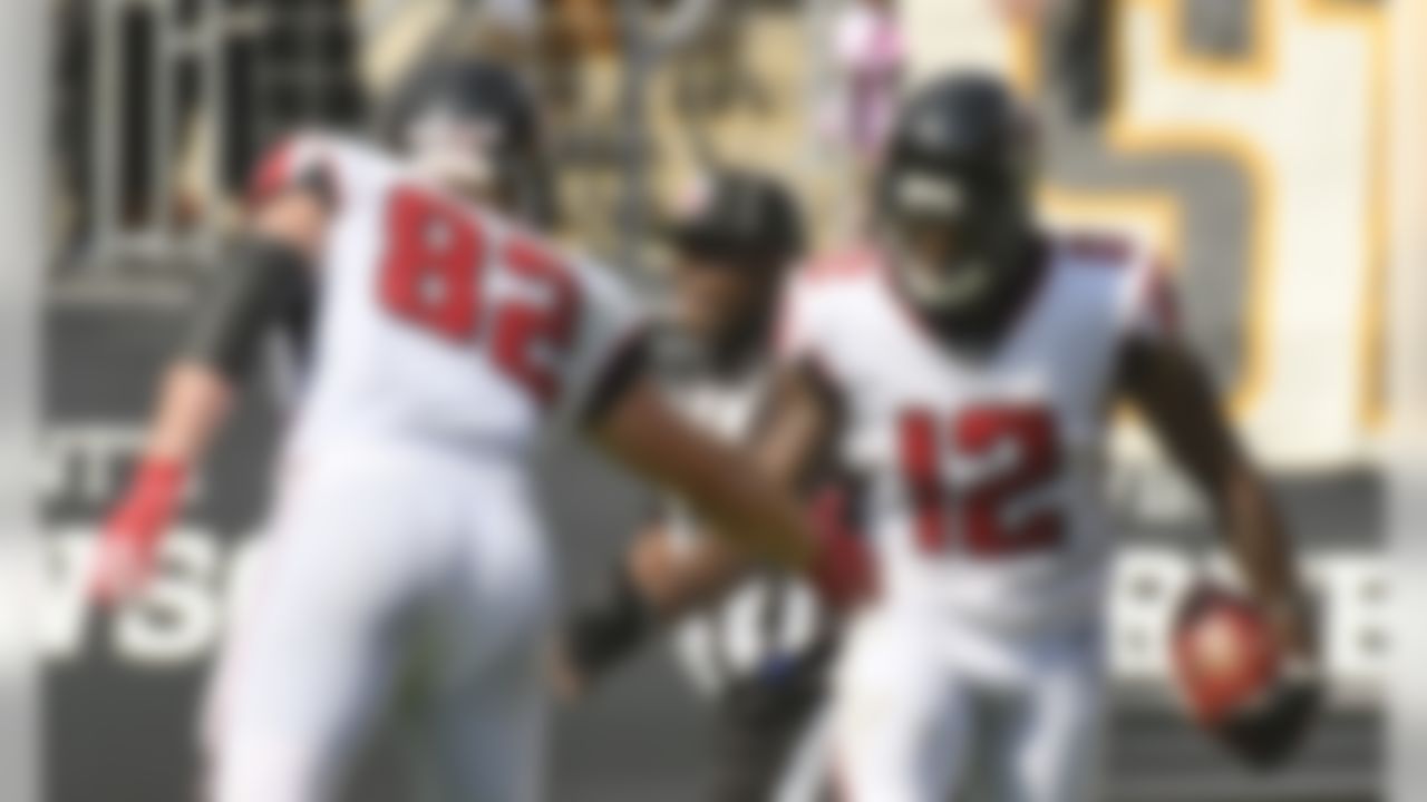 Atlanta Falcons wide receiver Mohamed Sanu (12) celebrates with tight end Logan Paulsen (82) after making a touchdown catch in the first half of an NFL football game against the Pittsburgh Steelers, Sunday, Oct. 7, 2018, in Pittsburgh. (AP Photo/Don Wright)