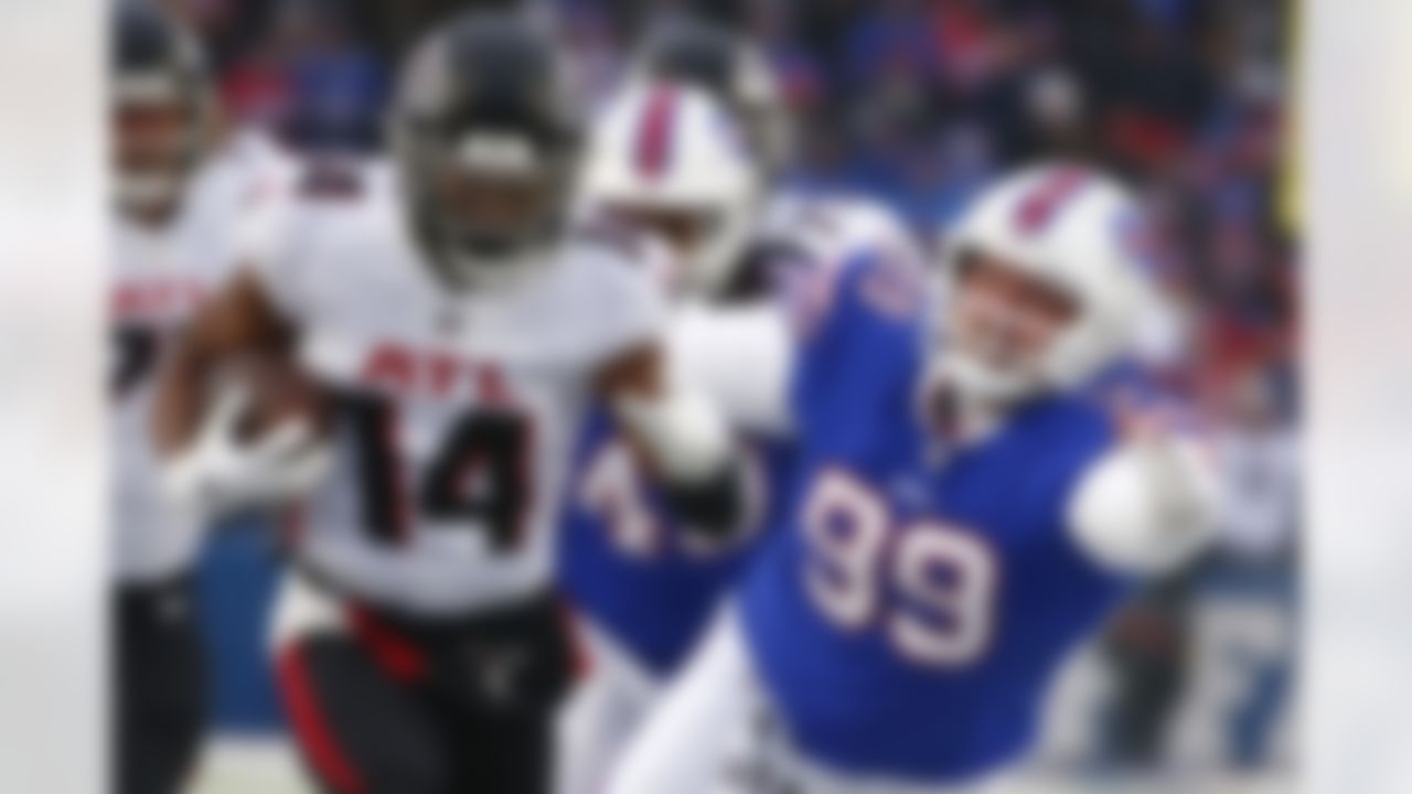 Atlanta Falcons' Russell Gage (14) runs past Buffalo Bills' Harrison Phillips (99) during the first half of an NFL football game Sunday, Jan. 2, 2022, in Orchard Park, N.Y.