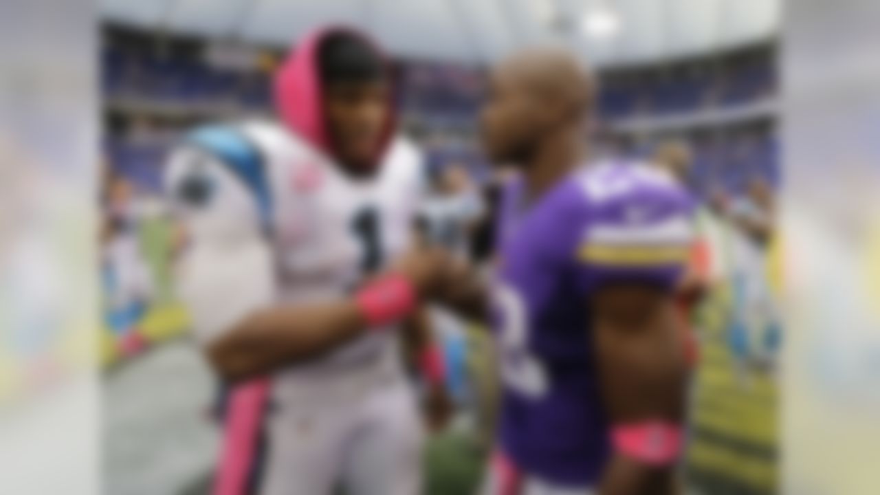 Minnesota Vikings running back Adrian Peterson, right, shakes hands with  Carolina Panthers quarterback Cam Newton following a 35-10 Panthers win in an NFL football game in Minneapolis, Sunday, Oct. 13, 2013. One of Peterson's sons, a 2-year-old in South Dakota, died Friday after an alleged attack in a child abuse case.(AP Photo/Ann Heisenfelt)