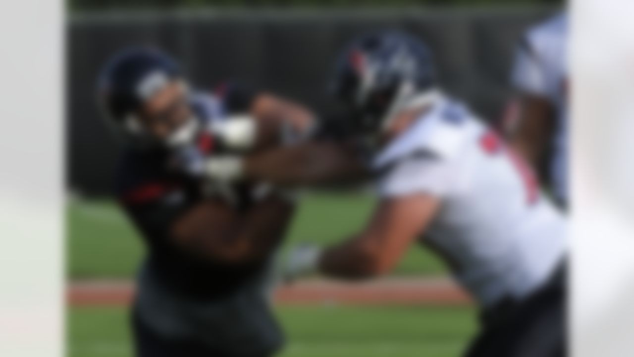 Houston Texans'  Cody Wallace (70) and  Hebron Fangupo, left, run a blocking drill on the first day of NFL football training camp Saturday, July 28, 2012, in Houston. (AP Photo/Pat Sullivan)
