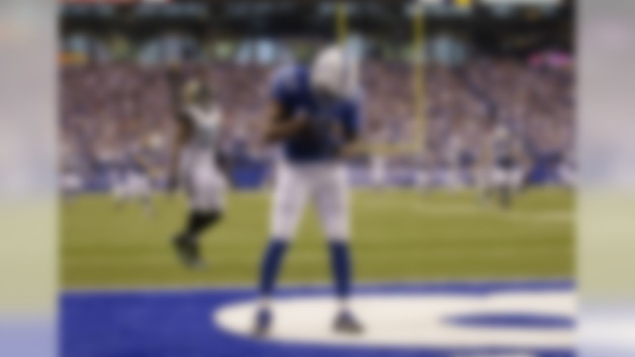 Indianapolis Colts wide receiver T.Y. Hilton (13) cradles the football after scoring on a 73-yard touchdown reception during the second half of an NFL football game against the Jacksonville Jaguars Sunday, Nov. 23, 2014 in Indianapolis. (AP Photo/AJ Mast)