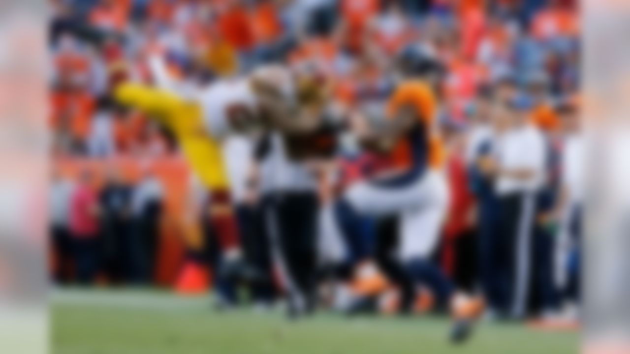 Washington Redskins cornerback DeAngelo Hall (23) intercepts the ball from Denver Broncos wide receiver Demaryius Thomas (88) during the NFL regular season game on Oct. 27, 2013 at the Sports Authority Field at Mile High in Denver. (Ric Tapia/NFL)