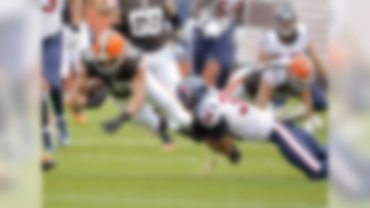 Houston Texans cornerback A.J. Bouye (34) tackles Cleveland Browns wide receiver Miles Austin after a first down catch in the first quarter of an NFL football game Sunday, Nov. 16, 2014, in Cleveland. (AP Photo/David Richard)