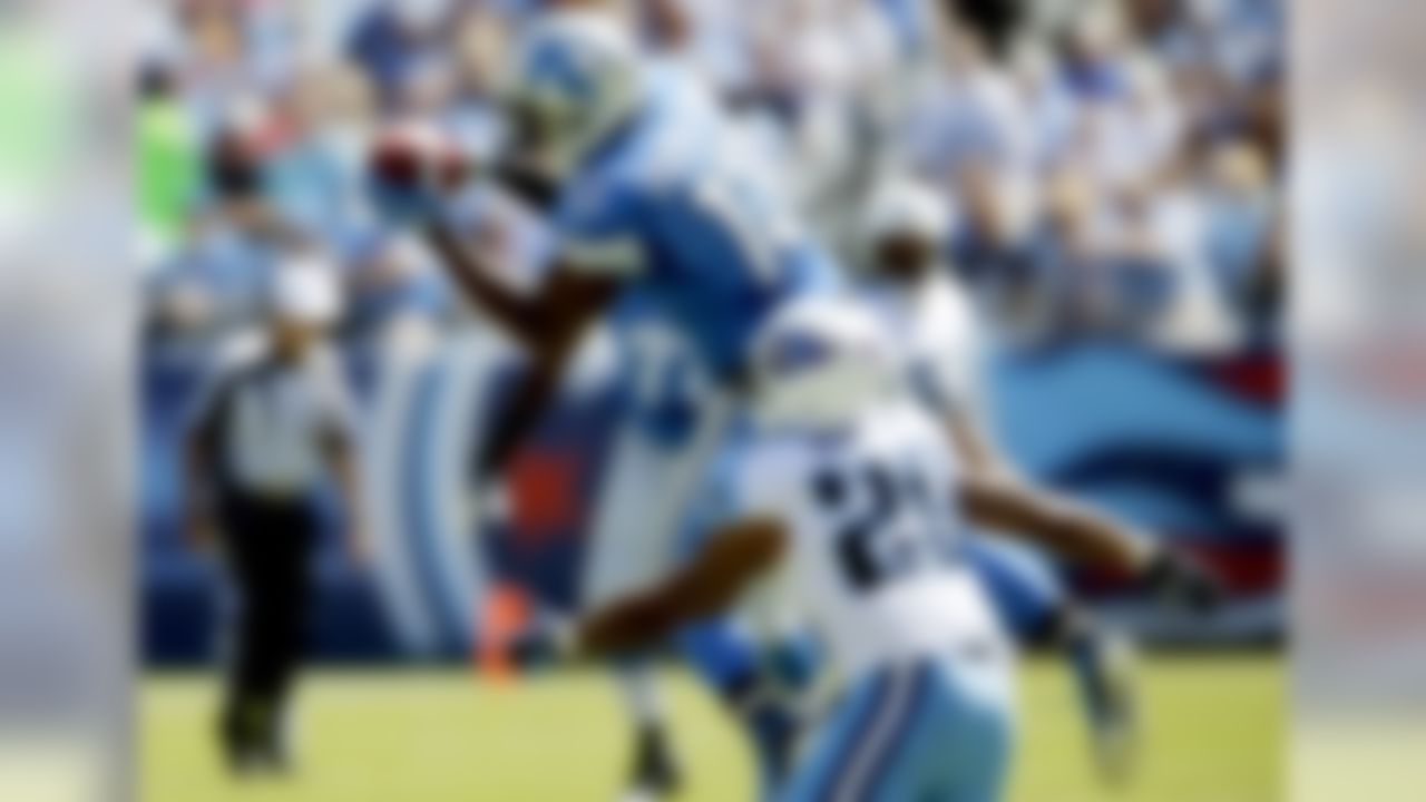 Detroit Lions wide receiver Nate Burleson (13) catches a pass as he is defended by Tennessee Titans cornerback Ryan Mouton (29) in the first quarter of an NFL football game, Sunday, Sept. 23, 2012, in Nashville, Tenn. (AP Photo/Joe Howell)