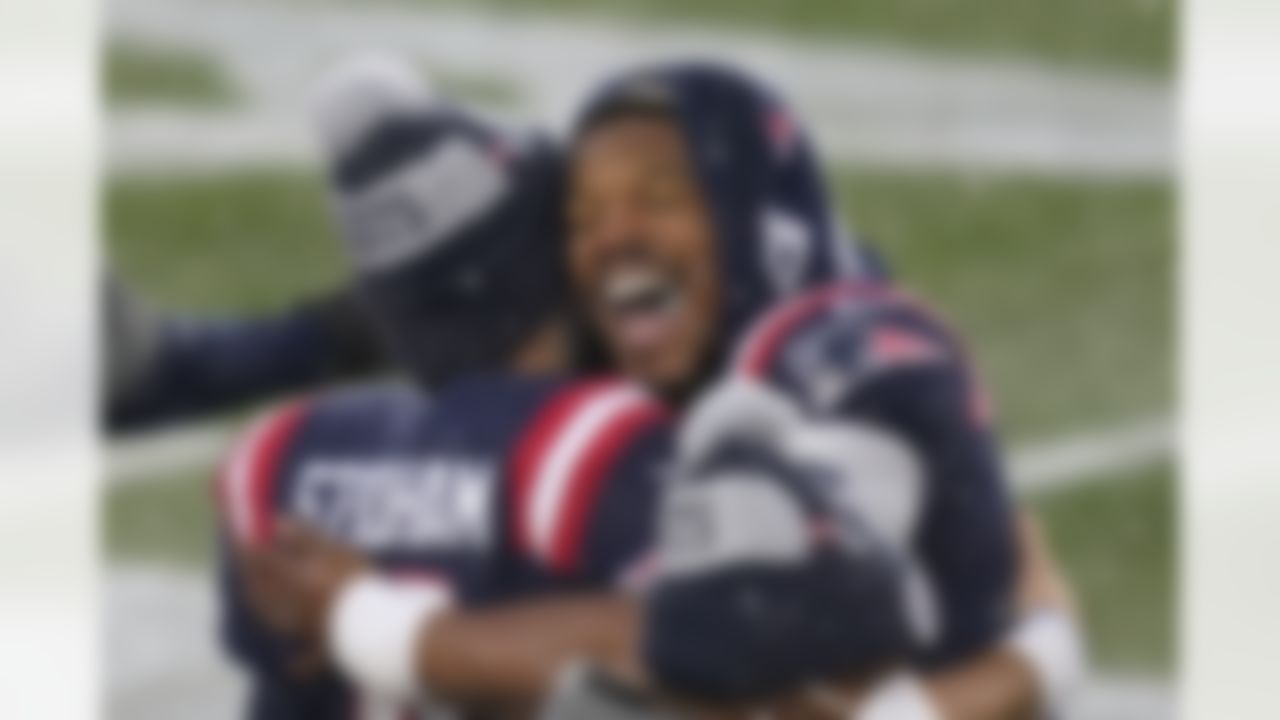 New England Patriots quarterbacks Jarrett Stidham, left, and Cam Newton embrace on the sideline at the end of an NFL football game against the New York Jets, Sunday, Jan. 3, 2021, in Foxborough, Mass.