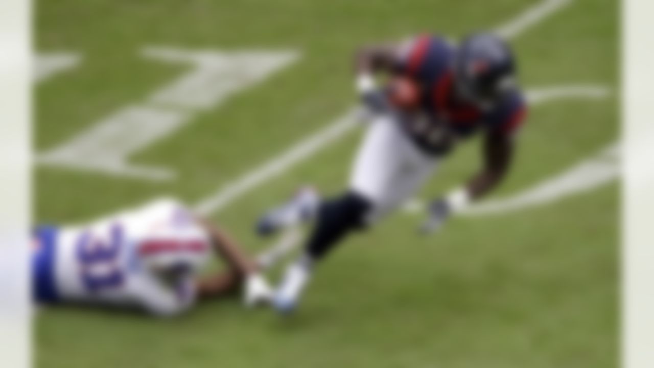 Houston Texans wide receiver Andre Johnson (80) is tripped up by Buffalo Bills free safety Jairus Byrd (31) after catching a pass in the first quarter of an NFL football game Sunday, Nov. 4, 2012, in Houston. (AP Photo/David J. Phillip)