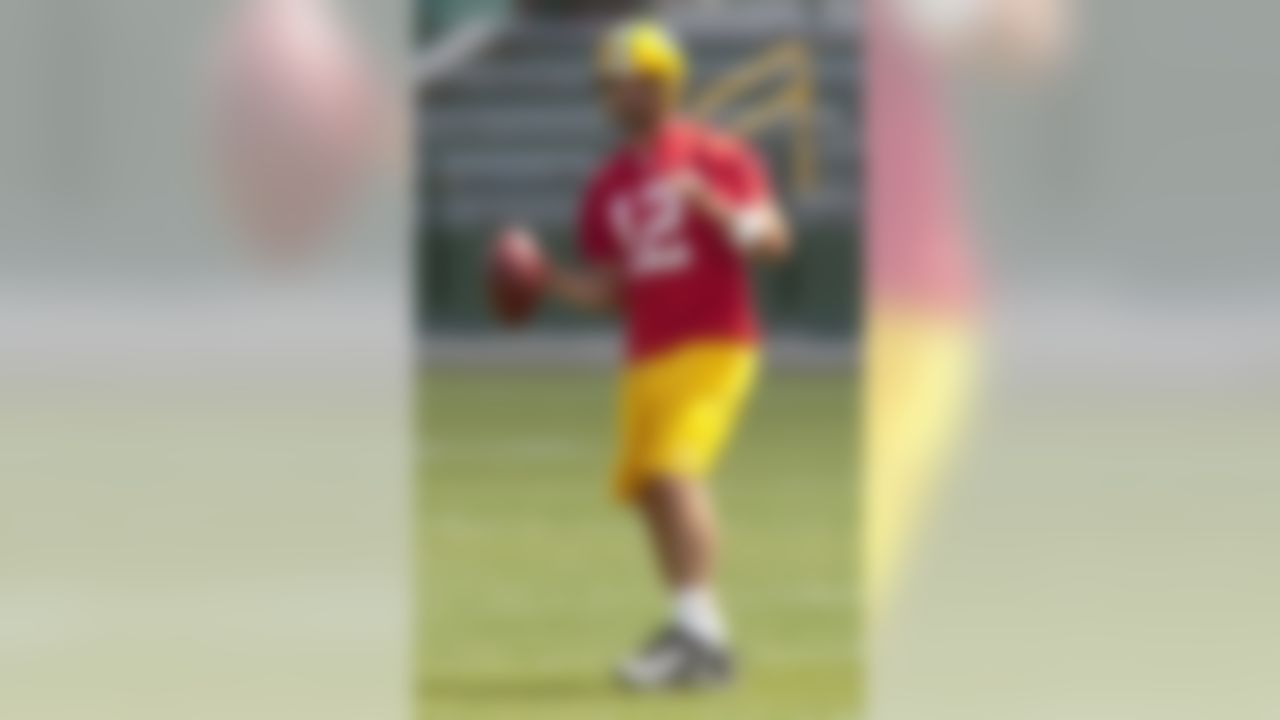 Green Bay Packers quarterback Aaron Rodgers  looks for a receiver during a Packers NFL football practice, Wednesday, June 9, 2010, in Green Bay, Wis. (AP Photo/Mike Roemer)