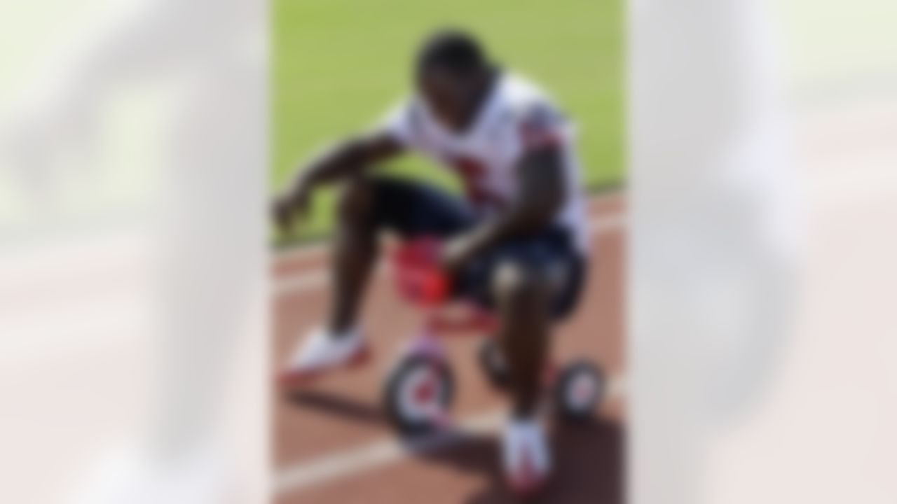 Houston Texans rookie wide receiver Trindon Holliday is made to ride a kids tricycle by veteran wide receiver Jacoby Jones after a NFL football training camp practice Wednesday, Aug. 4, 2010,  in Houston. (AP Photo/David J. Phillip)