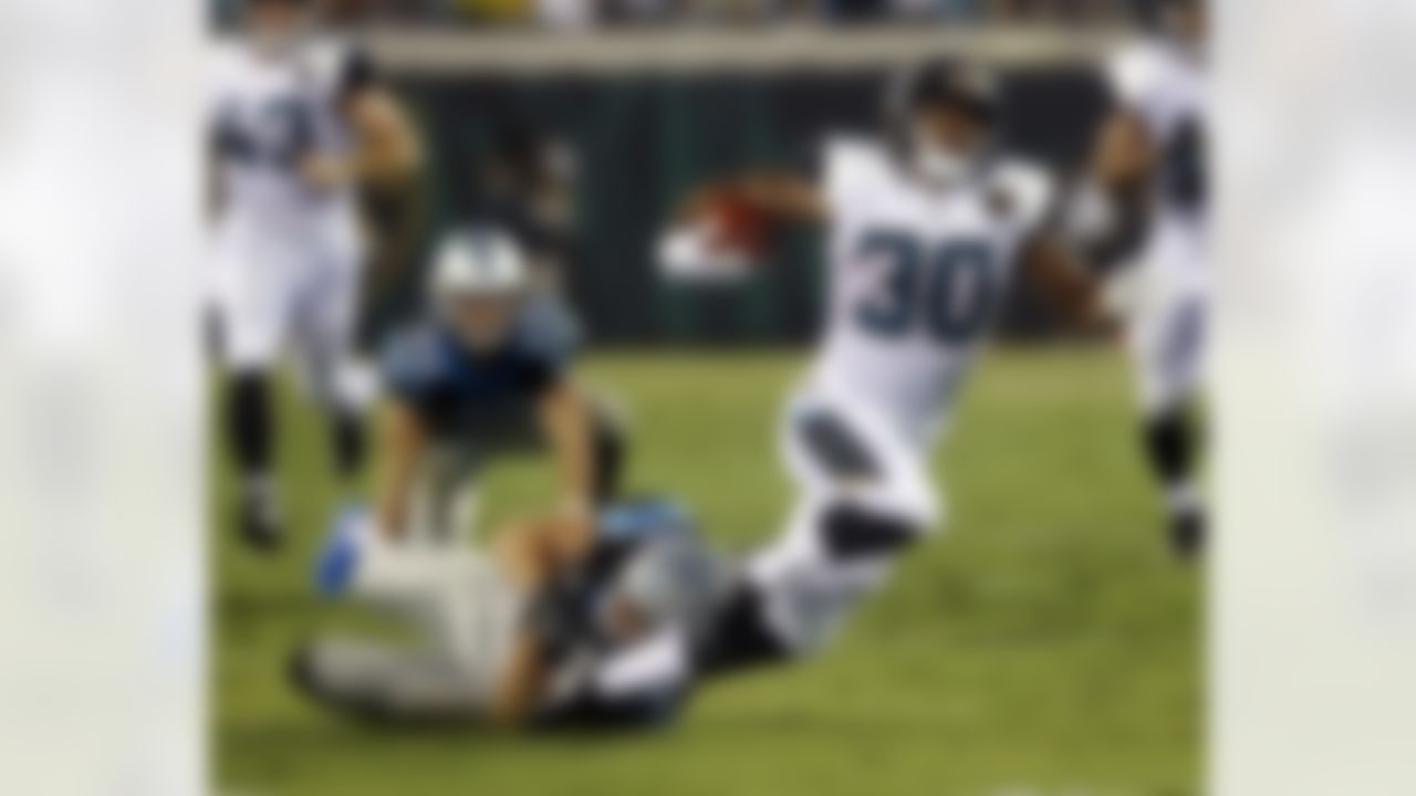 Jacksonville Jaguars running back Corey Grant (30) is tripped up by Carolina Panthers safety Colin Jones after running for more than 50 yards on a fake punt during the first half of an NFL preseason football game, Thursday, Aug. 24, 2017, in Jacksonville, Fla. (AP Photo/Stephen B. Morton)
