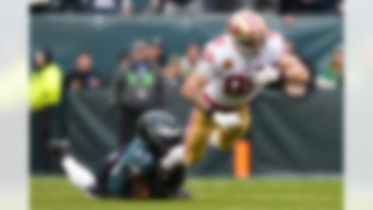 San Francisco 49ers tight end George Kittle (85) dives forward while being tackled by Philadelphia Eagles linebacker Kyzir White (43) during the first half of the NFC Championship NFL football game between the Philadelphia Eagles and the San Francisco 49ers on Sunday, Jan. 29, 2023, in Philadelphia.