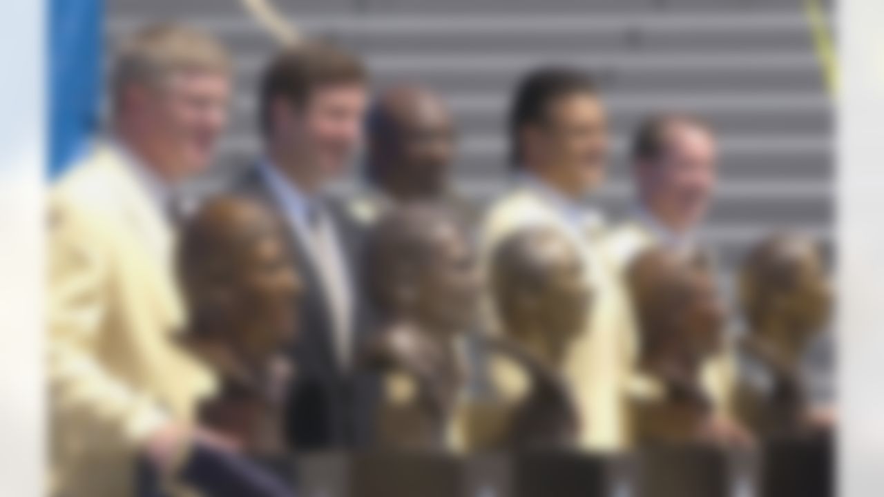 The Class of 2002 pose with their busts after enshrinement into the Pro Football Hall of Fame in Canton, Ohio Saturday, Aug. 3, 2002. From left: Dave Casper, Sen. George Allen for his father, the late coach George Allen, John Stallworth, Dan Hampton and Jim Kelly. (AP Photo/Mark Duncan)