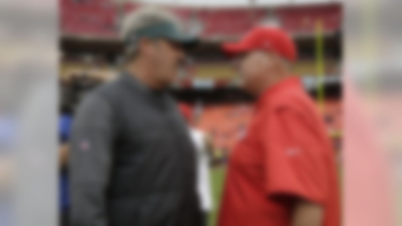 Philadelphia Eagles head coach Doug Pederson, left, chats with Kansas City Chiefs head coach Andy Reid before an NFL football game in Kansas City, Mo., Sunday, Sept. 17, 2017. (AP Photo/Charlie Riedel)