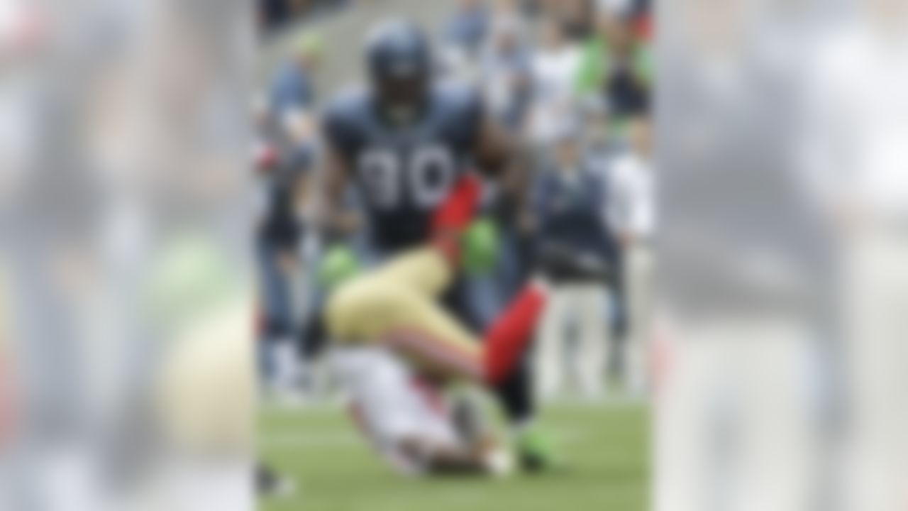 Seattle Seahawks' Colin Cole stands over San Francisco 49ers' Frank Gore after Gore made a catch and was tackled in the first half of an NFL football game, Sunday, Sept. 12, 2010, in Seattle. (AP Photo/Ted S. Warren)