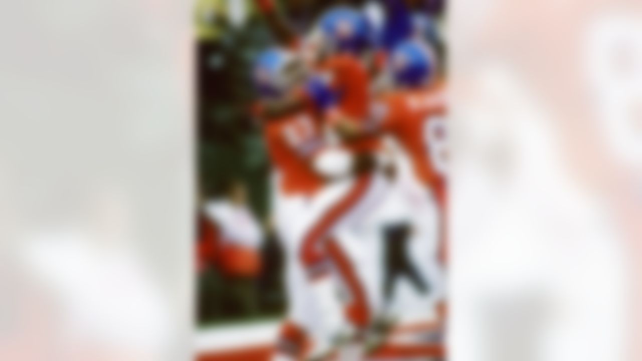 Denver Broncos wide receiver Ricky Nattiel (84) jumps into the arms of running back Sammy Winder (23) after Nattiel caught a 56-yard touchdown pass during Super Bowl XXII, a 42-10 loss to the Washington Redskins on January 31, 1988, at Jack Murphy Stadium. (National Football League)
