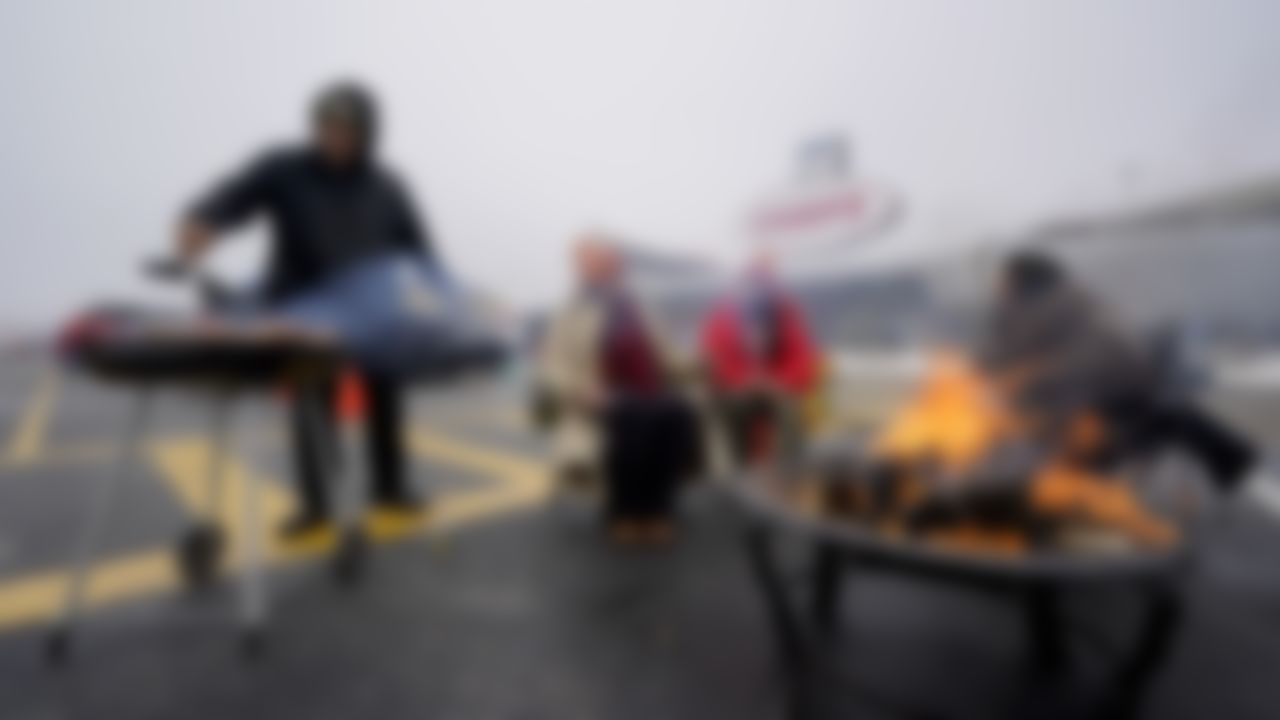 Fans tailgate in the parking lot outside Arrowhead Stadium before an NFL football game between the Los Angeles Chargers and the Kansas City Chiefs, Sunday, Jan. 3, 2021, in Kansas City, Mo.
