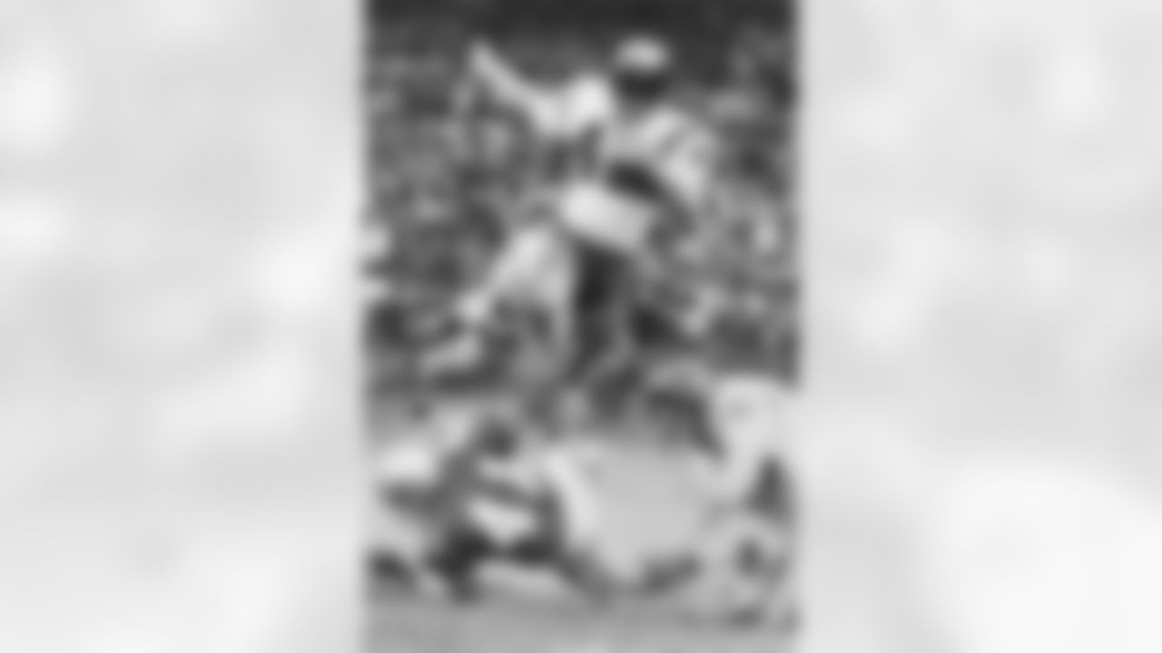 Washington Redskins rookie halfback Charley Taylor (42) carries the football during the Redskins 28-16 victory over the Dallas Cowboys on November 22, 1964 at DC Stadium in Washington, D.C. Taylor was named NFL Rookie of the Year. (National Football League)