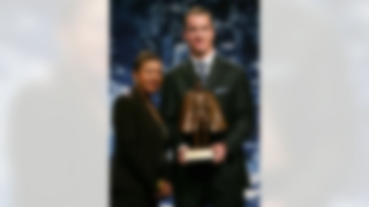DETROIT - FEBRUARY 03: Peyton Manning of the Indianapolis Colts and Connie Payton, wife of deceased star Walter Payton, hold the Walter Payton Man of the Year trophy during a press conference on February 3, 2006 at the Renaissance Center in Detroit, Michigan. (Photo by Jonathan Daniel/Getty Images)