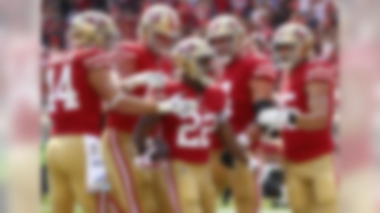 San Francisco 49ers running back Matt Breida (22) is congratulated by teammates after scoring a touchdown against the Arizona Cardinals during the first half of an NFL football game in Santa Clara, Calif., Sunday, Oct. 7, 2018. (AP Photo/Ben Margot)