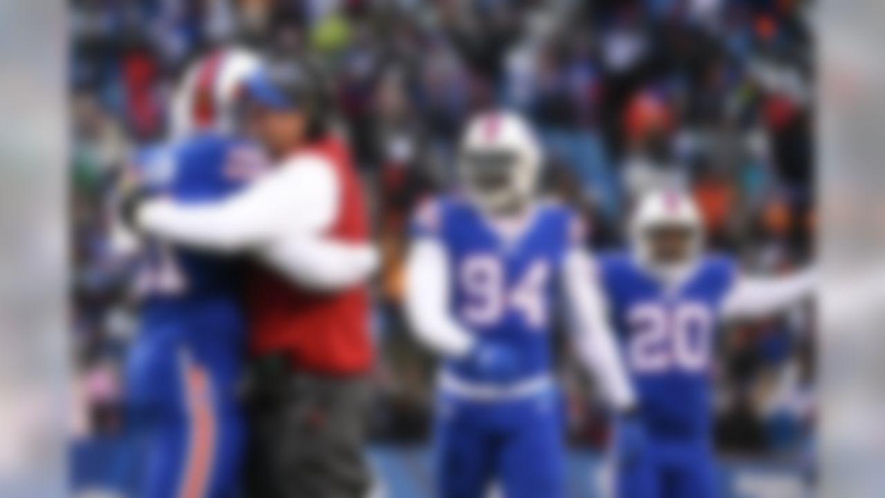 Buffalo Bills head coach Rex Ryan hugs Buffalo Bills' Manny Lawson (91) after Lawson intercepted a pass during the second half of an NFL football game against the New York Jets Sunday, Jan. 3, 2016, in Orchard Park, N.Y. The Bills won 22-17. (AP Photo/Gary Wiepert)