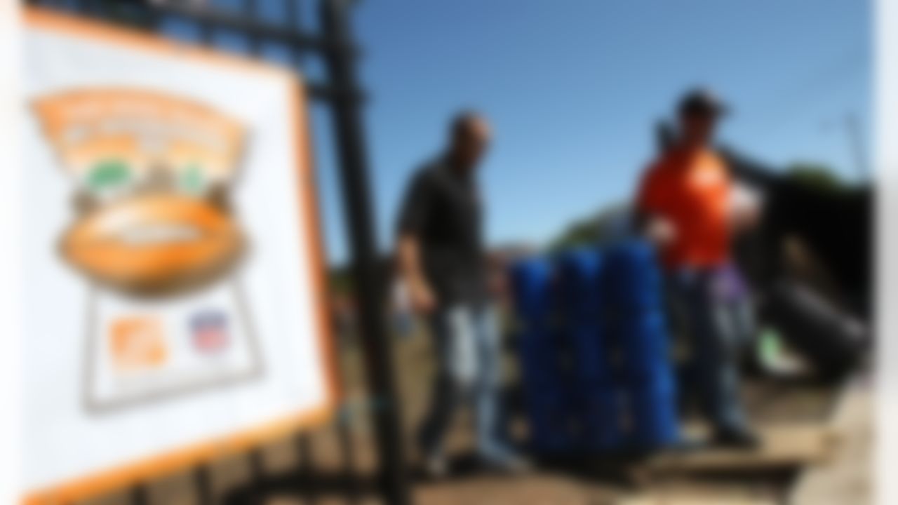 Mike Furrey and David Rock carry over the new tic-tac-toe board to the playground site. (Photo by Tom Copeland/Home Depot)