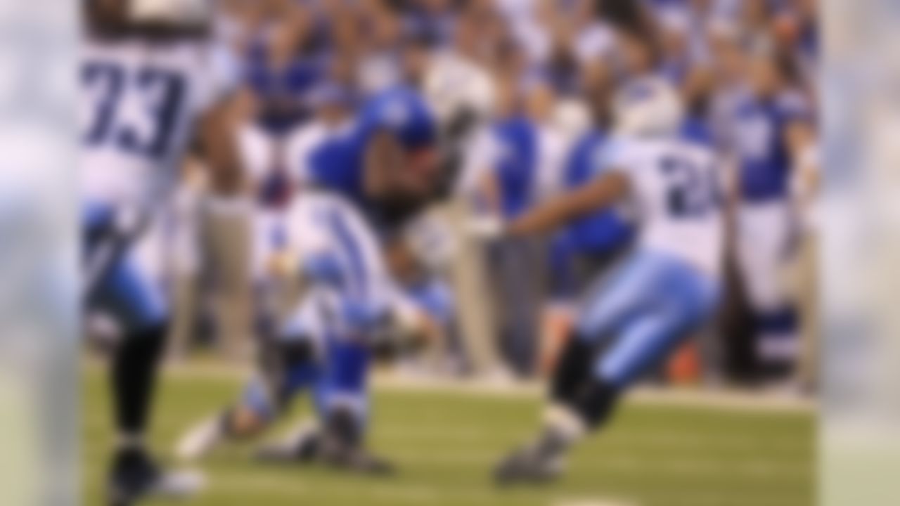 Indianapolis Colts running back Joseph Addai is tackled by Tennessee Titans cornerback Cortland Finnegan in the first quarter of an NFL football game in Indianapolis, Sunday, Jan. 2, 2011. (AP Photo/Michael Conroy)