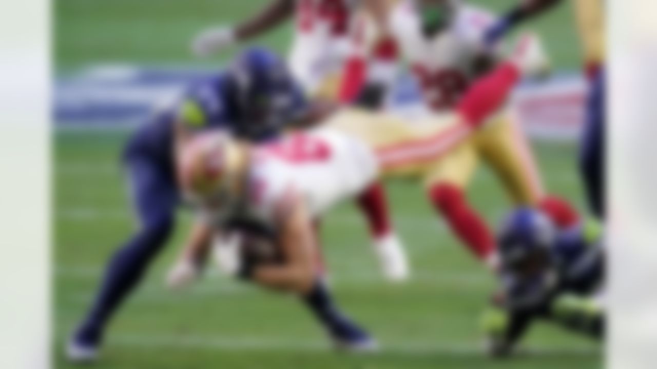 San Francisco 49ers tight end George Kittle (85) is hit by Seattle Seahawks safety Ugo Amadi (28) and middle linebacker Bobby Wagner (54) during the first half of an NFL football game, Sunday, Jan. 3, 2021, in Glendale, Ariz.