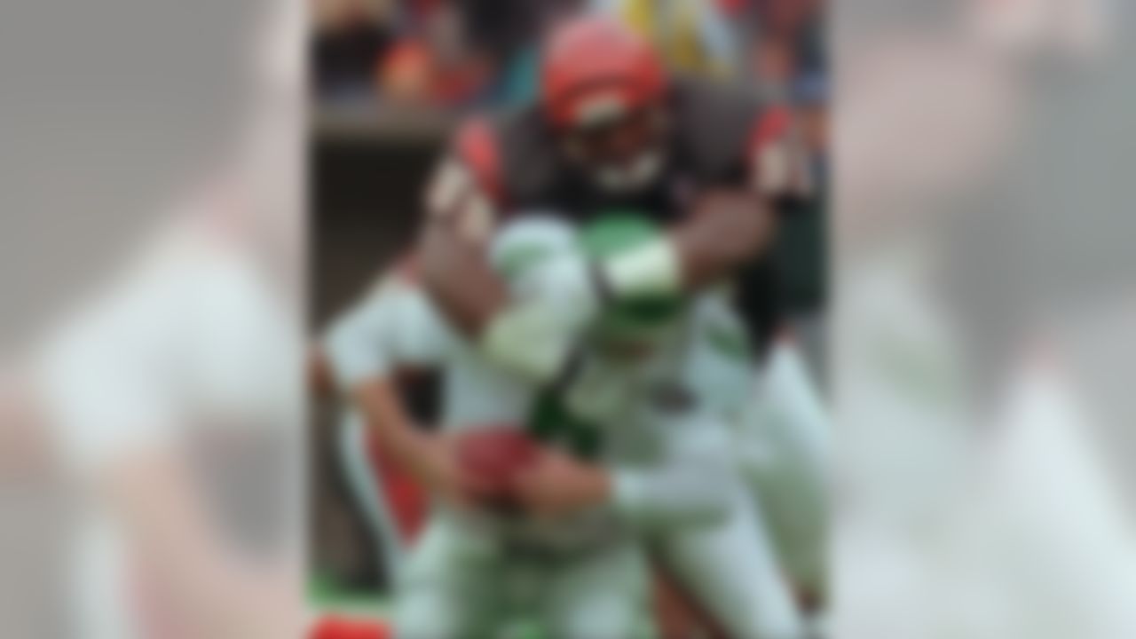 Cincinnati Bengals defensive tackle Dan Wilkinson (99) sacks Phildelphia Eagles quarterback Bubby Brister (6) during the second half Saturday, Dec. 24, 1994, in Cincinnati. (AP Photo/Tom Uhlman)