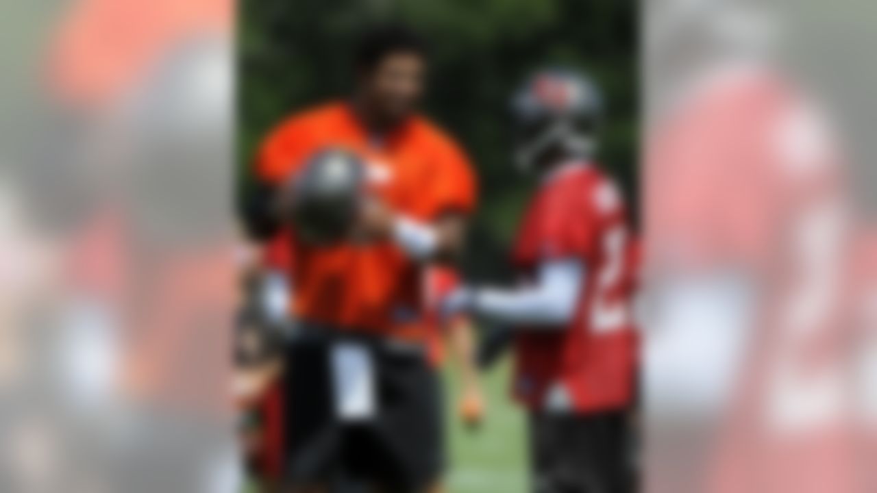 Tampa Bay Buccaneers quarterback Josh Freeman, left, laughs with cornerback Ronde Barber, right, during NFL training camp on Saturday, July 30, 2011 in Tampa, Fla. (AP Photo/Brian Blanco)