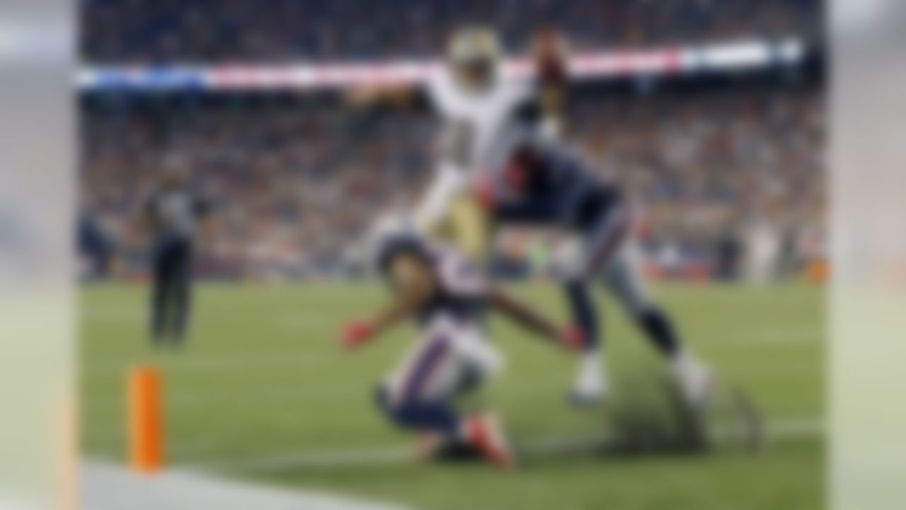 New Orleans Saints quarterback Garrett Grayson (18) scores on a two-point conversion past New England Patriots safety Patrick Chung (23) and defensive lineman Jabaal Sheard, right, during the first half of a preseason NFL football game Thursday, Aug. 11, 2016, in Foxborough, Mass. (AP Photo/Winslow Townson)