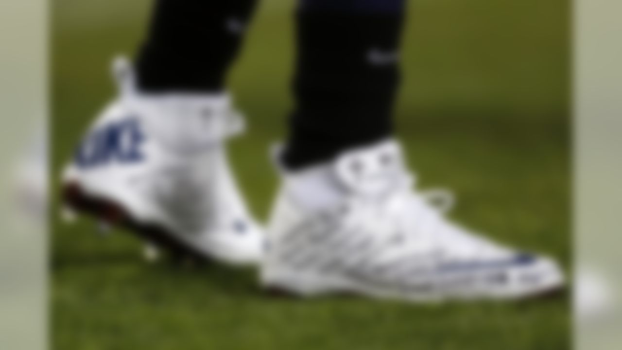 Tennessee Titans running back Chris Johnson wears a pair of shoes with the names of the victims of the Sandy Hook Elementary School shootings in Newtown, Conn., during warmups before an NFL football game against the New York Jets, Monday, Dec. 17, 2012, in Nashville, Tenn. (AP Photo/Joe Howell)