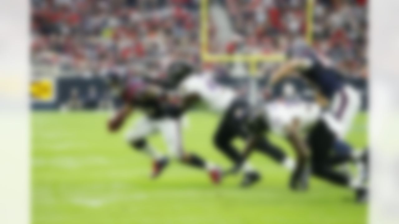 Houston Texans running back Arian Foster (23) rushes against the Baltimore Ravens as Courtney Upshaw (91) attempts the tackle during an NFL football game Sunday, Dec. 21, 2014, in Houston. (AP Photo/Matt Patterson)