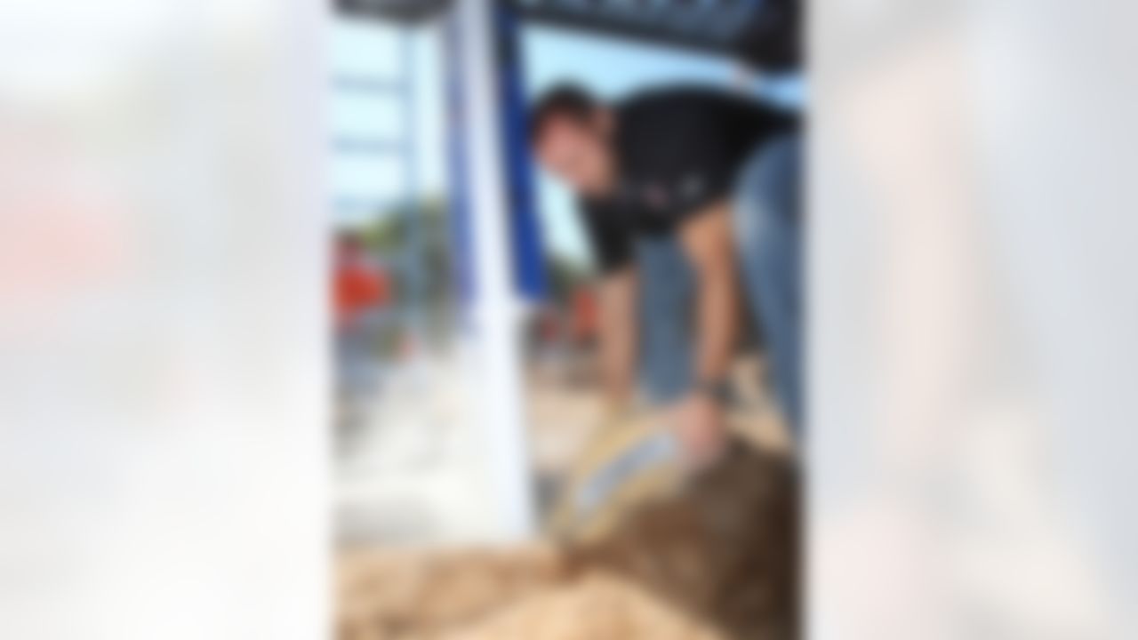 Mike Furrey helps pour concrete on the base of the new playground. (Photo by Tom Copeland/Home Depot)