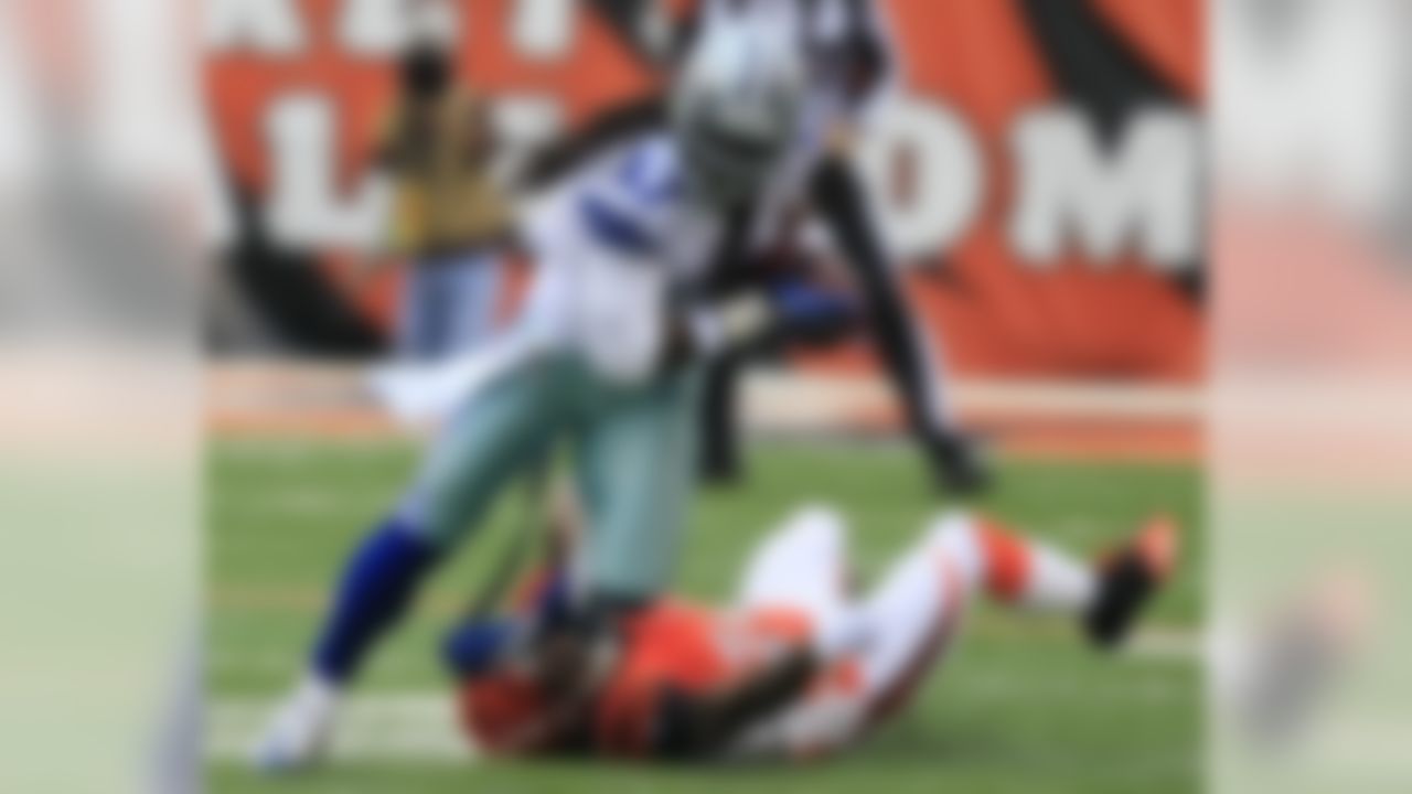 Dallas Cowboys wide receiver Dwayne Harris (17) runs past Cincinnati Bengals cornerback Adam Jones (24) after catching a pass in the first half of an NFL football game, Sunday, Dec. 9, 2012, in Cincinnati. (AP Photo/Al Behrman)