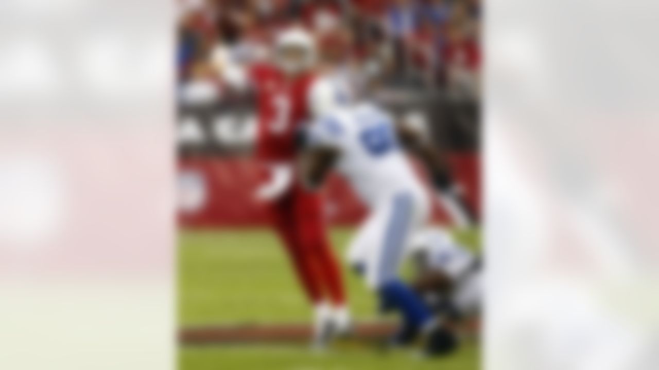 Arizona Cardinals quarterback Carson Palmer (3) throws over Indianapolis Colts defensive end Cory Redding (90) during the first half of an NFL football game, Sunday, Nov. 24, 2013, in Glendale, Ariz. (AP Photo/Rick Scuteri)