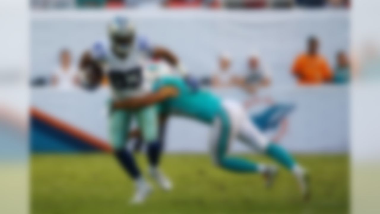 Miami Dolphins cornerback Brent Grimes (21) tackles Dallas Cowboys wide receiver Terrance Williams (83) during the first half of an NFL preseason football game, Saturday, Aug. 23, 2014 in Miami Gardens, Fla. (AP Photo/J Pat Carter)