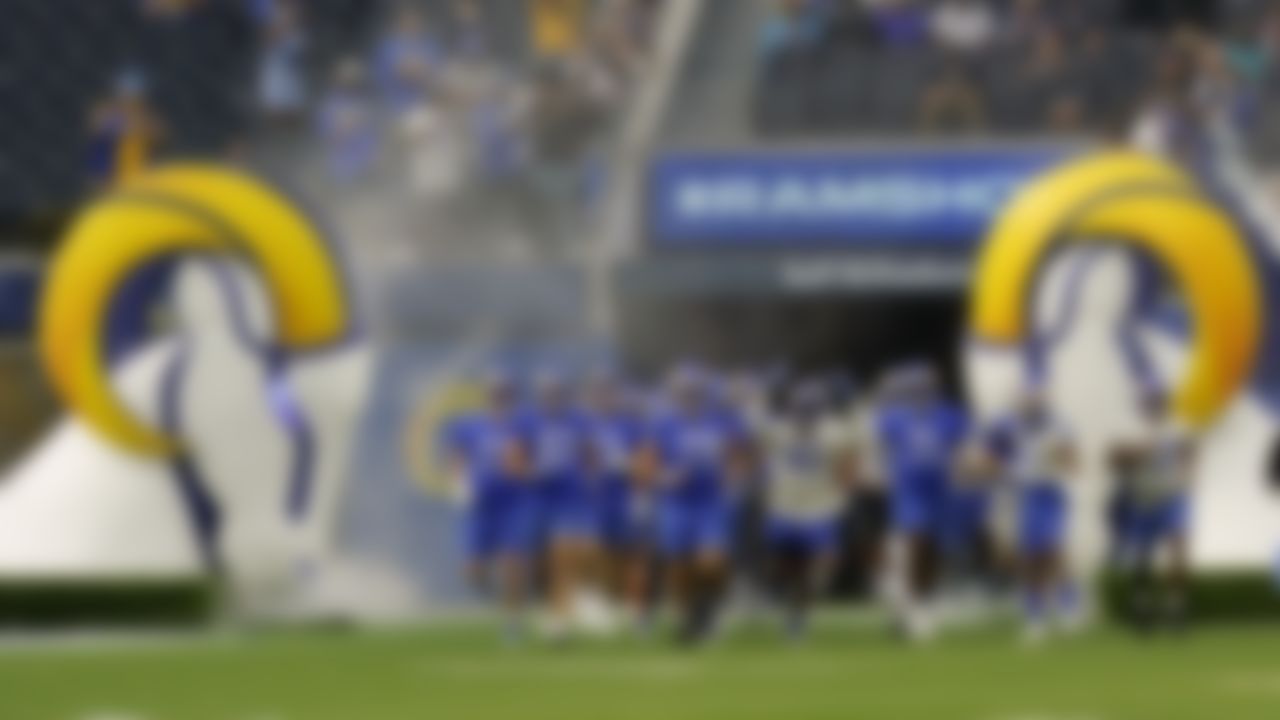 Fans watch as the Los Angeles Rams enter the field during NFL football camp Thursday, June 10, 2021, in Inglewood, Calif.
