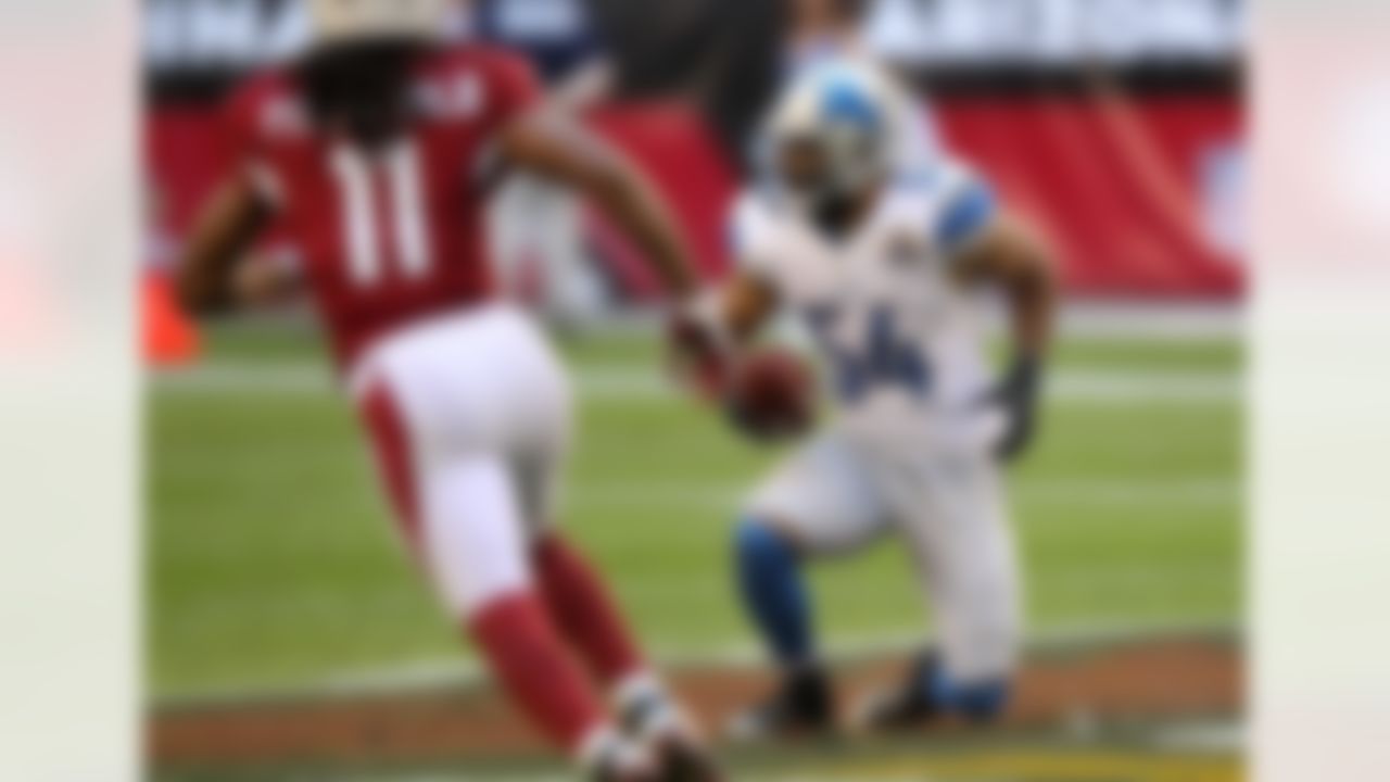 Detroit Lions outside linebacker DeAndre Levy (54) makes an interception as Arizona Cardinals wide receiver Larry Fitzgerald (11) pursues during the first half of an NFL football game on Sunday, Dec. 16, 2012, in Glendale, Ariz. (AP Photo/Paul Connors)