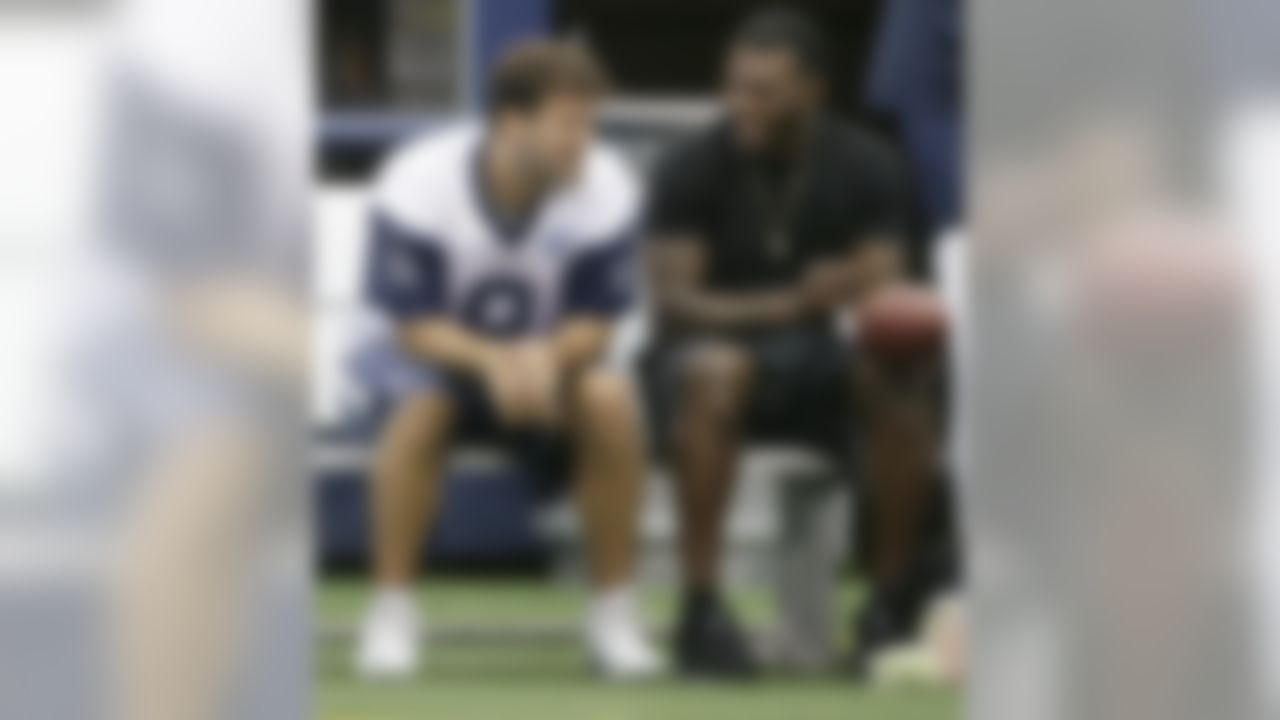 Dallas Cowboys wide receiver Dez Bryant, right, sits on the bench with quarterback Tony Romo (9) during an NFL football minicamp at the team's stadium in Arlington, Texas, in Arlington, Texas, Thursday, June 18, 2015. Bryant joined his teammates for the last day of minicamp. Bryant didn't practice Thursday since he still has not signed his franchise tender that would guarantee him $12.8 million this season. (AP Photo/LM Otero)