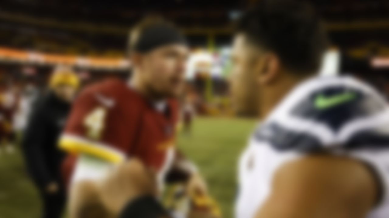 Washington Football Team quarterback Taylor Heinicke (4) talks with Seattle Seahawks quarterback Russell Wilson (3) after an NFL football game on Monday, November 29, 2021 in Landover, Maryland.