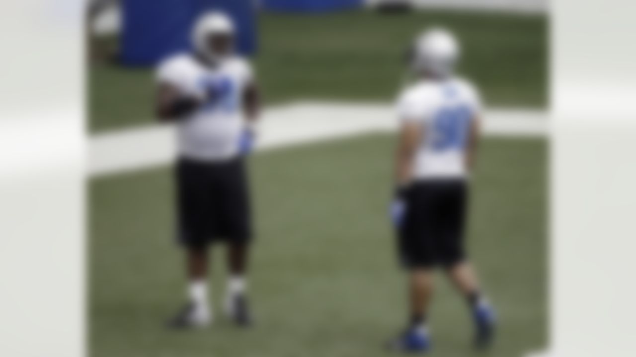 Detroit Lions defensive tackle Nick Fairley, left, asks Ndamukong Suh, right, a question during NFL football training camp the team's indoor training facility in Allen Park, Mich., Friday, July 29, 2011. (AP Photo/Paul Sancya)