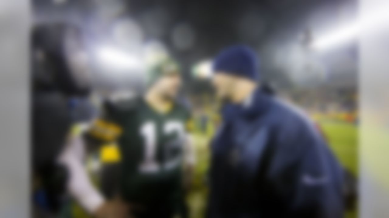 Green Bay Packers quarterback Aaron Rodgers (12) and Dallas Cowboys quarterback Tony Romo (9) talk following a NFL football game between the Dallas Cowboys and the Green Bay Packers during week 14 on December 13, 2015 in Green Bay, WI. The Packers beat the Cowboys 28-7. (Todd Rosenberg/NFL)