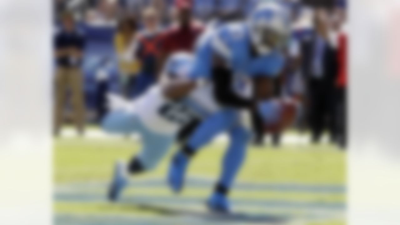 Detroit Lions wide receiver Nate Burleson (13) catches a touchdown pass as he is defended by Tennessee Titans cornerback Ryan Mouton (29) in the fourth quarter of an NFL football game on Sunday, Sept. 23, 2012, in Nashville, Tenn. (AP Photo/Wade Payne)