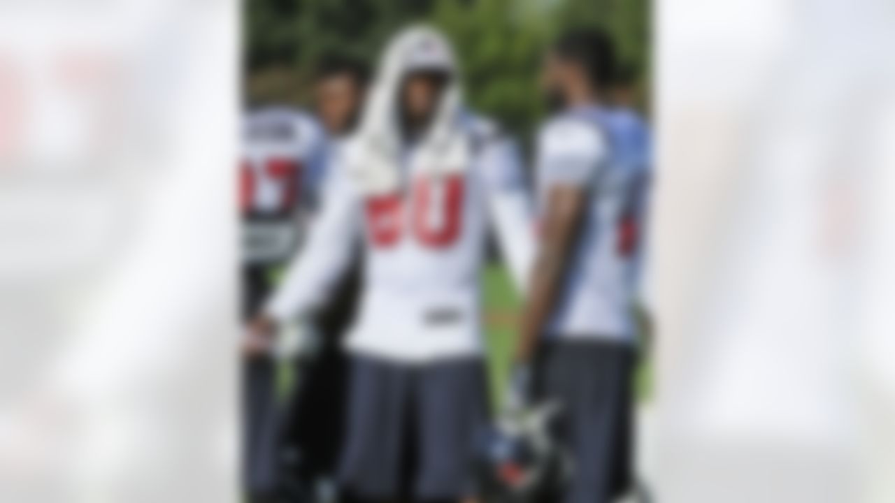 Houston Texans wide receiver Andre Johnson (80) talks with Lestar Jean during training camp Monday, July 30, 2012, in Houston. Johnson will not be practicing for at least a week after injuring a groin muscle in Sunday's practice. (AP Photo/Pat Sullivan)