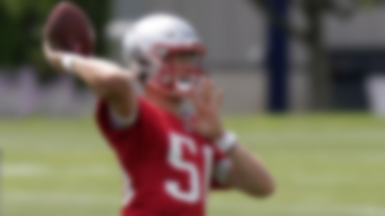 New England Patriots quarterback Mac Jones winds up to pass during an NFL football practice, in Foxborough, Mass., Thursday, June 10, 2021.