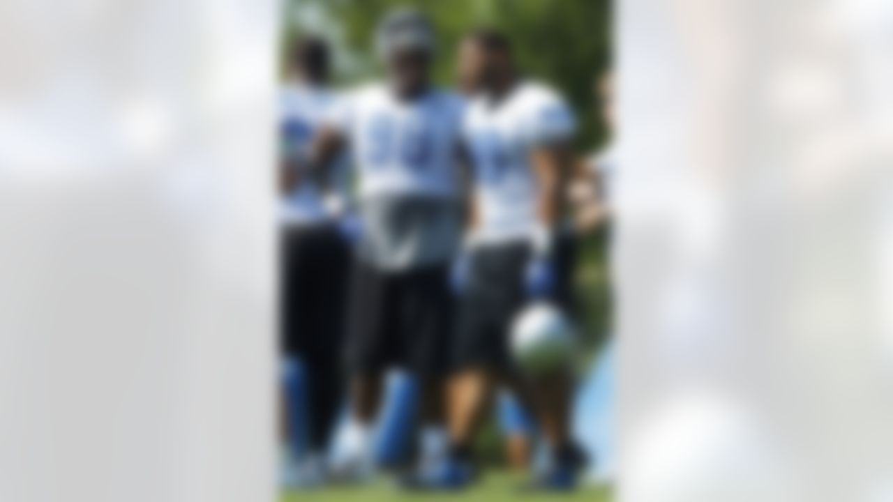 Detroit Lions defensive tackle Nick Fairley (98) and defensive tackle Ndamukong Suh (90) talk during NFL football training camp at the team's practice facility in Allen Park, Mich., Saturday, July 30, 2011. (AP Photo/Rick Osentoski)
