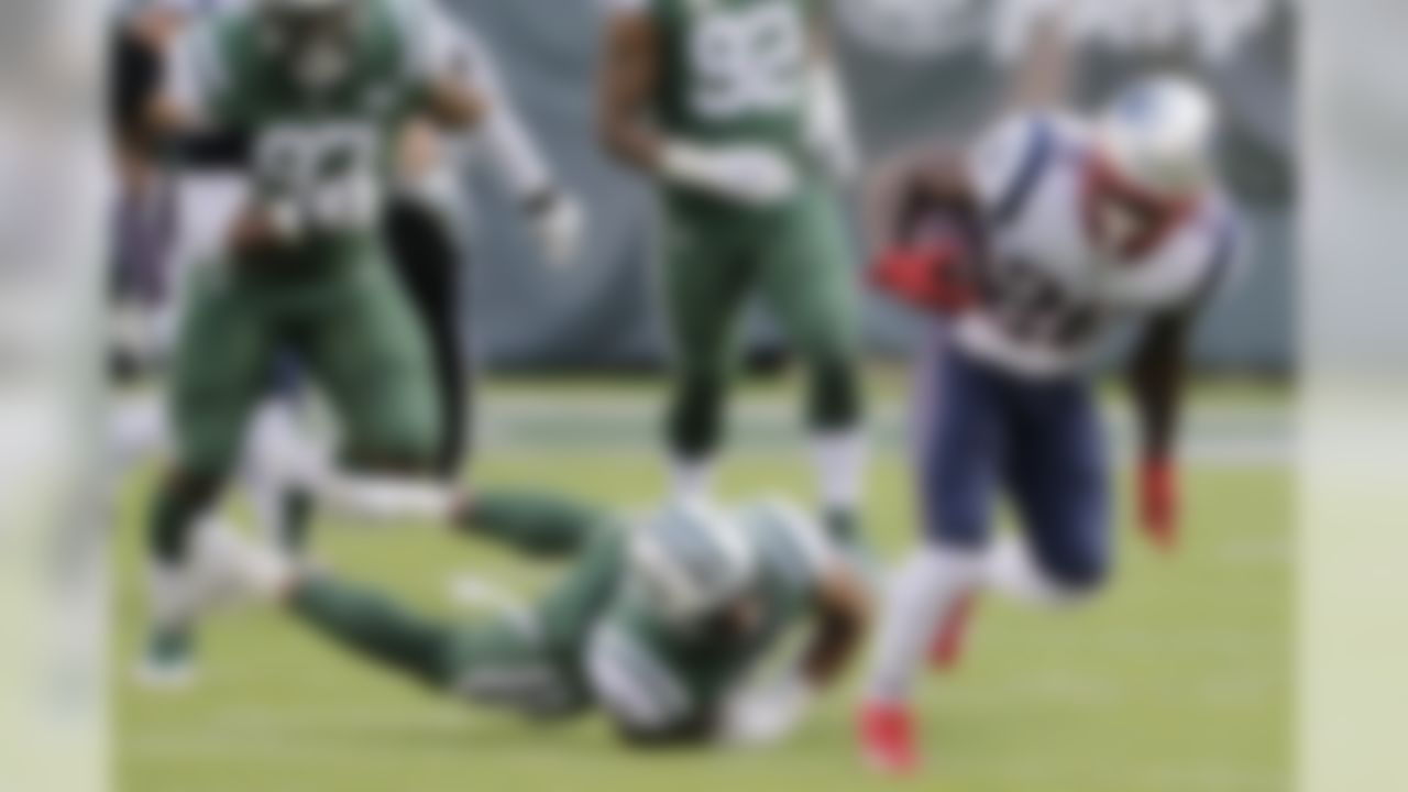 New England Patriots' Sony Michel (26) breaks a tackle by New York Jets' Frankie Luvu (50) during the second half of an NFL football game Sunday, Nov. 25, 2018, in East Rutherford, N.J. (AP Photo/Seth Wenig)